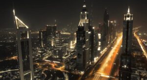 Dubai skyline at night with illuminated towers along Sheikh Zayed Road