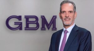 GBM executive standing in front of GBM branding at the UAE AI Lab launch