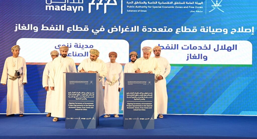 Officials signing investment agreements in Oman under OPAZ and Madayn banners